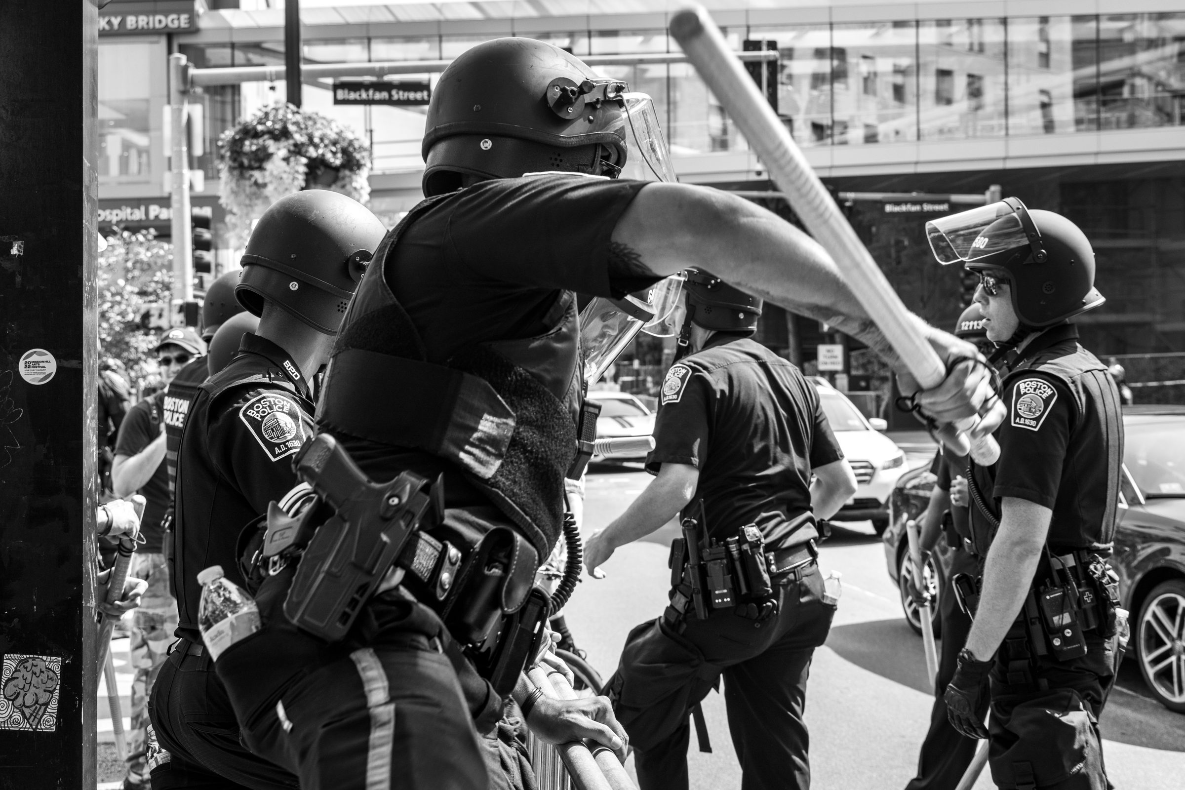 Officer swinging baton during confrontation