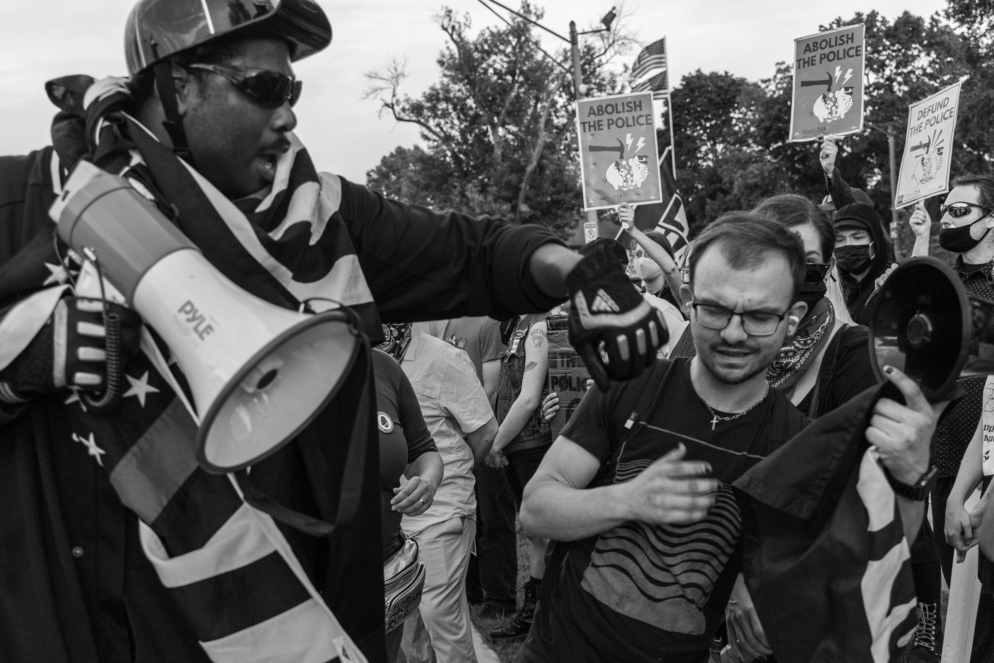 Protester with megaphone confronting counter-protester