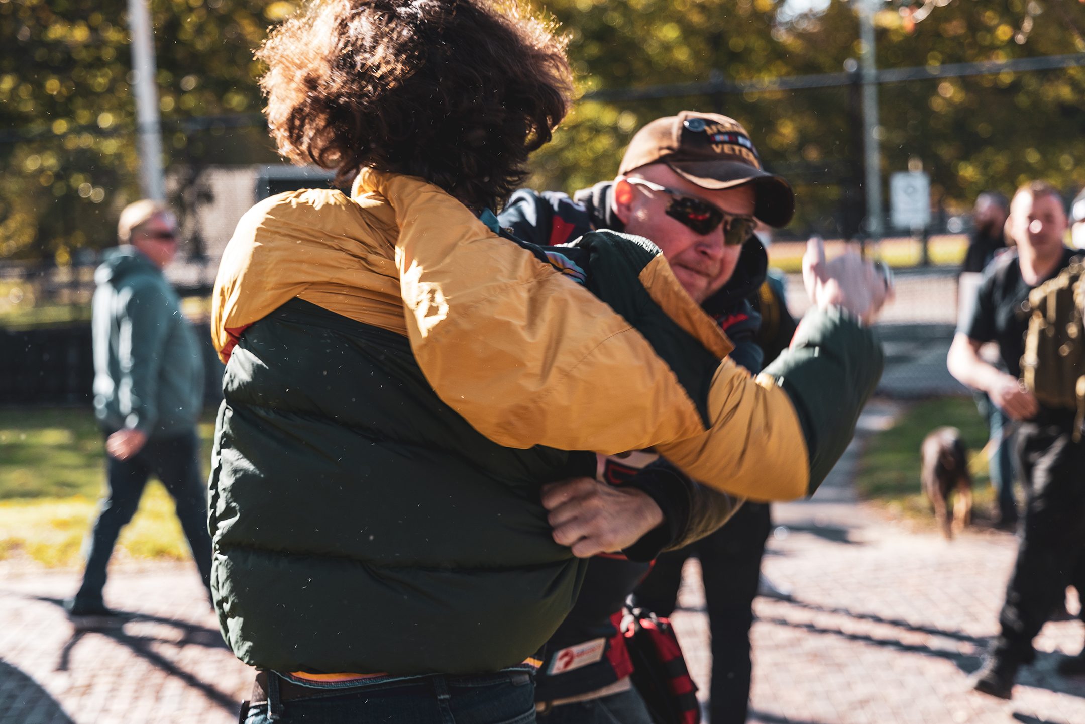 Two people grappling at protest