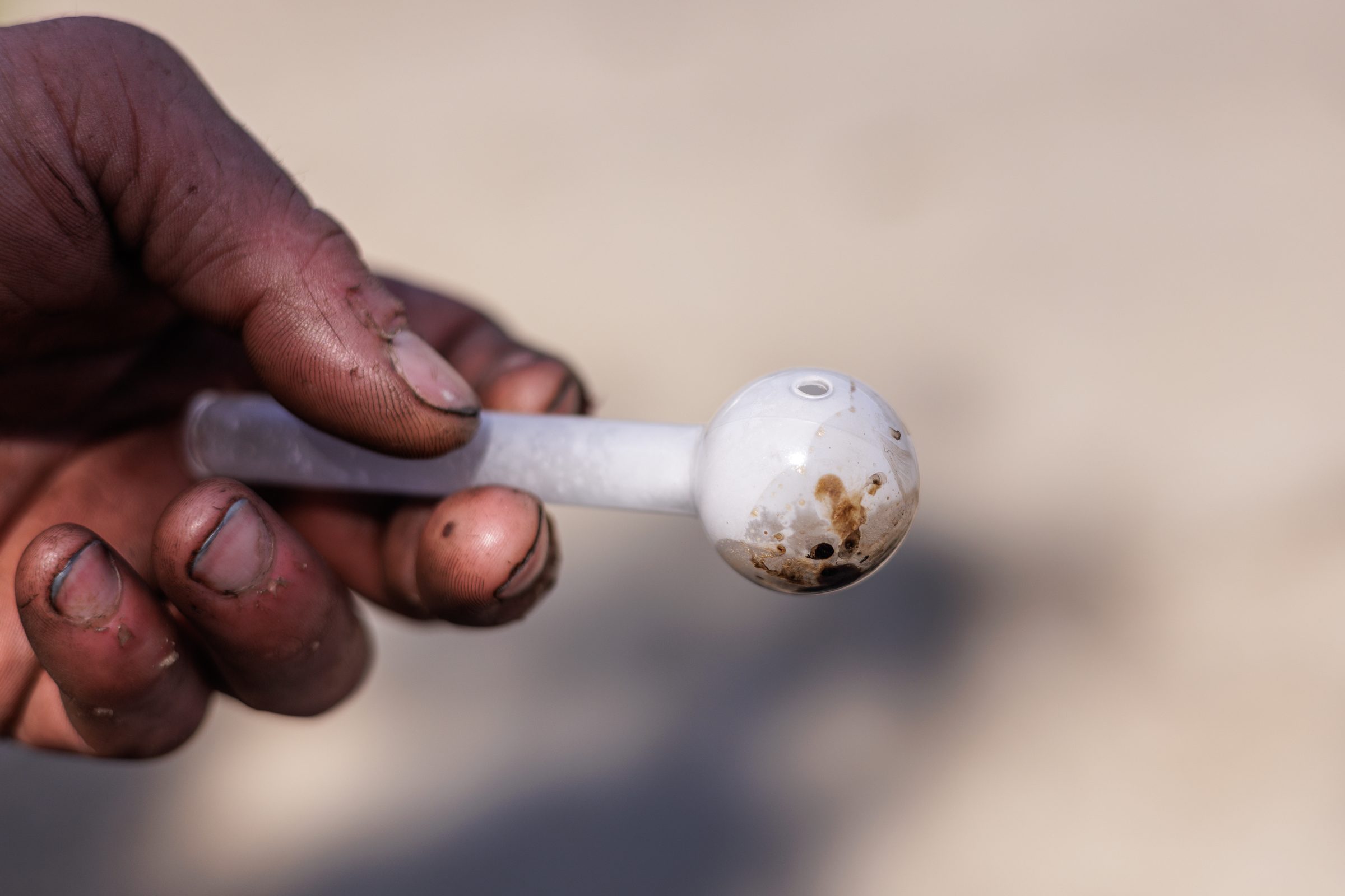 Hand holding a glass pipe