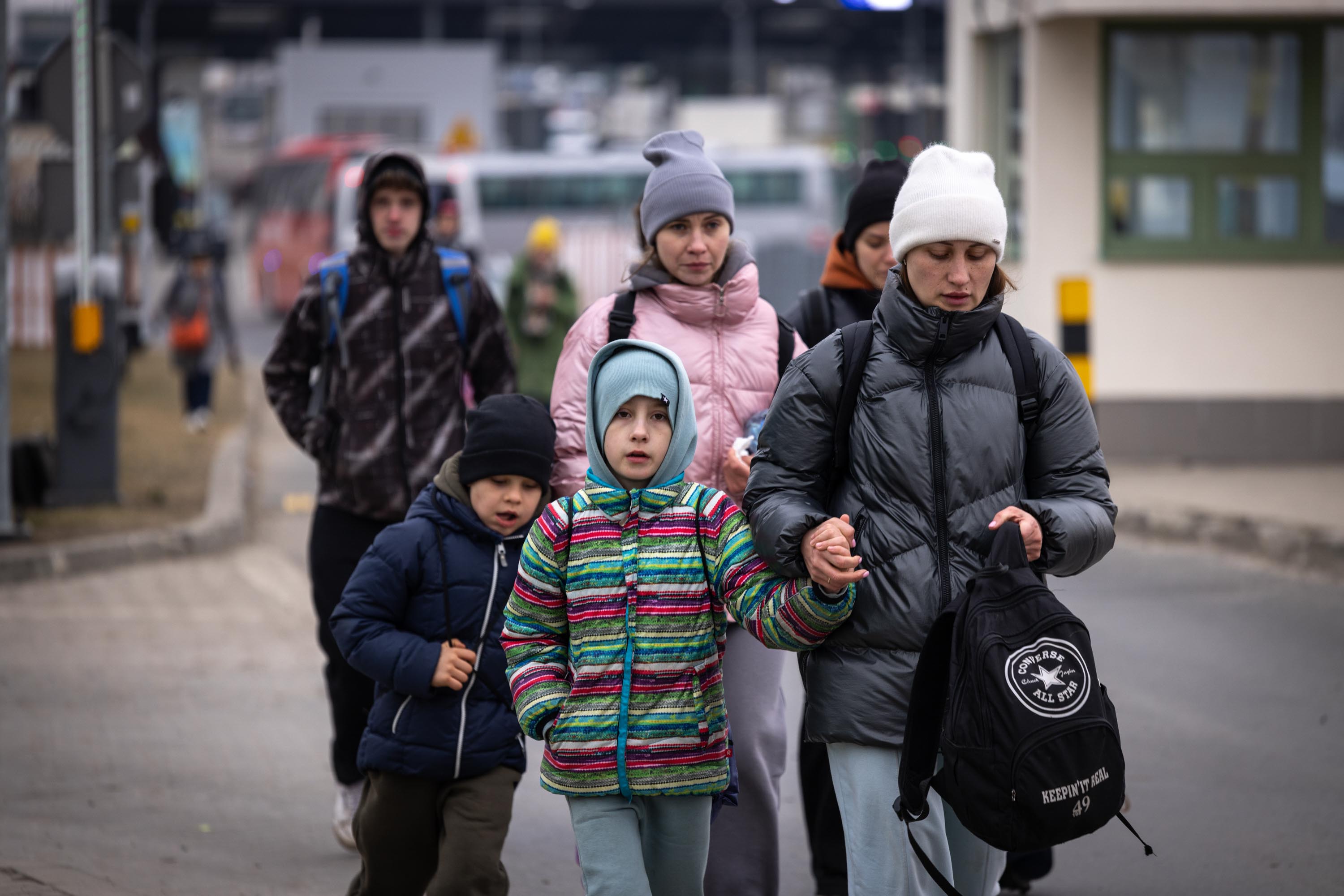 Family with children crossing the border on foot